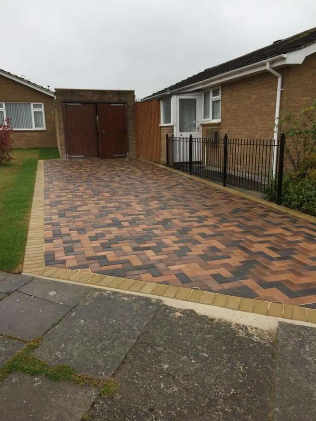 Brindle herringbone block paving driveway with new lawn and iron railings